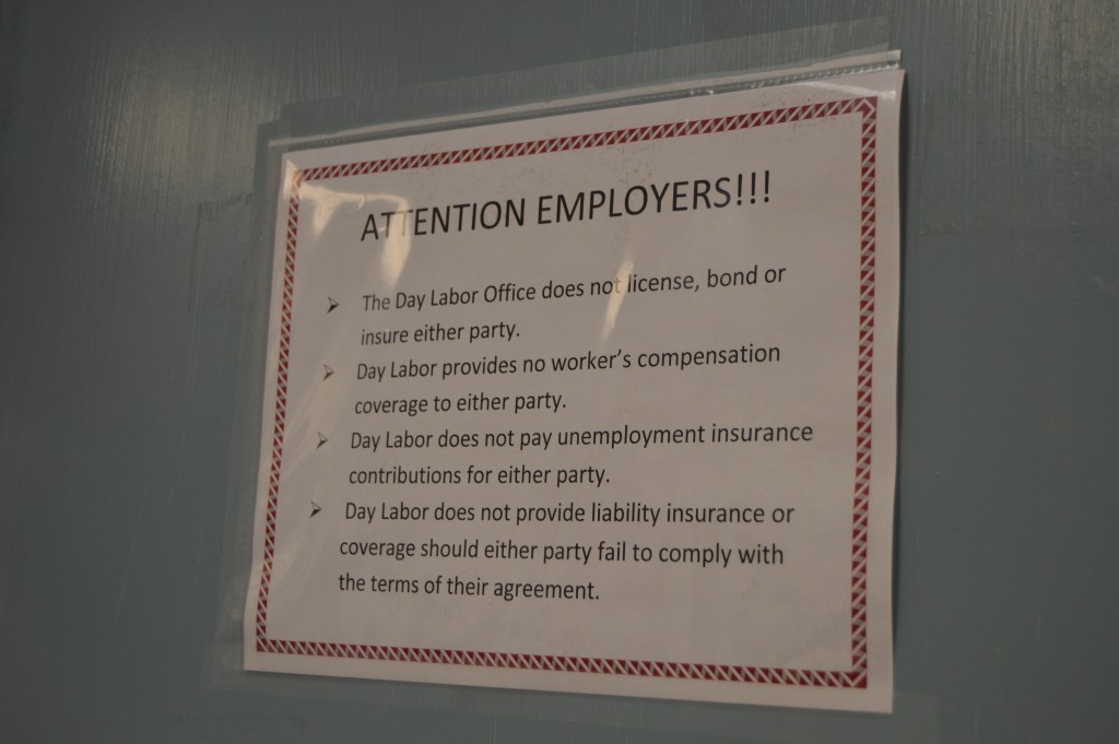 A sign adorning the exit to the Day Labor Office informs employers of their rights and liabilities. – Photo by Michael Olinger.