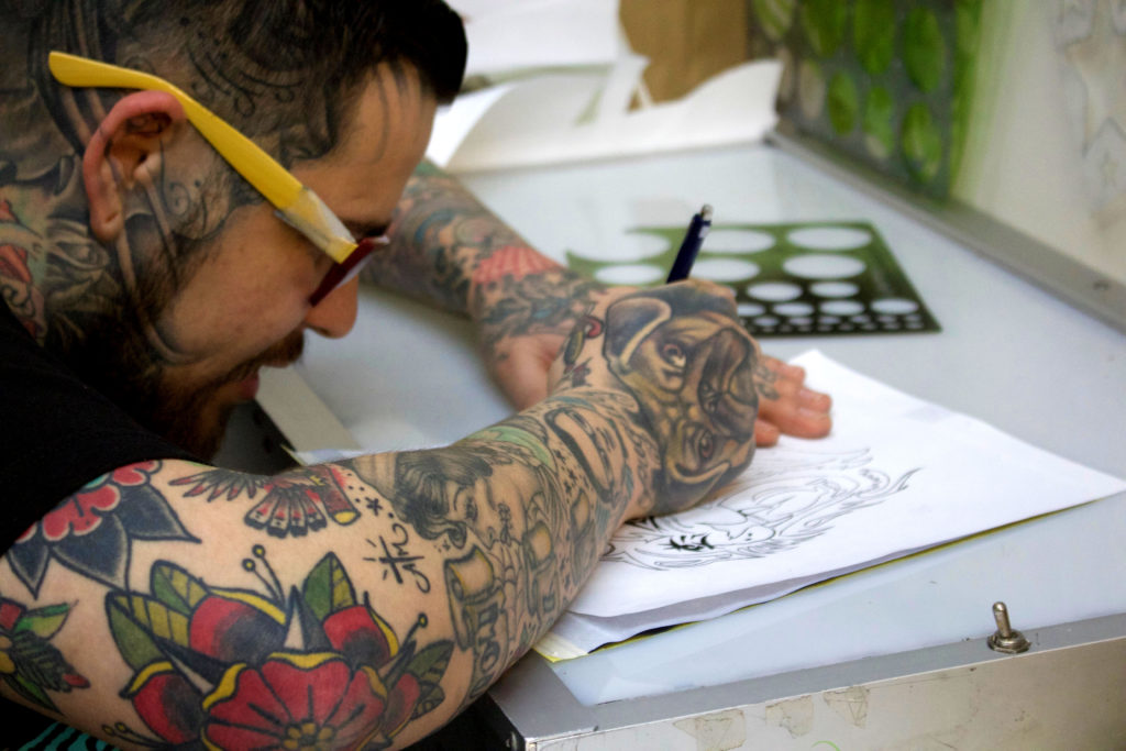 Albert Rivas sketching a tattoo
