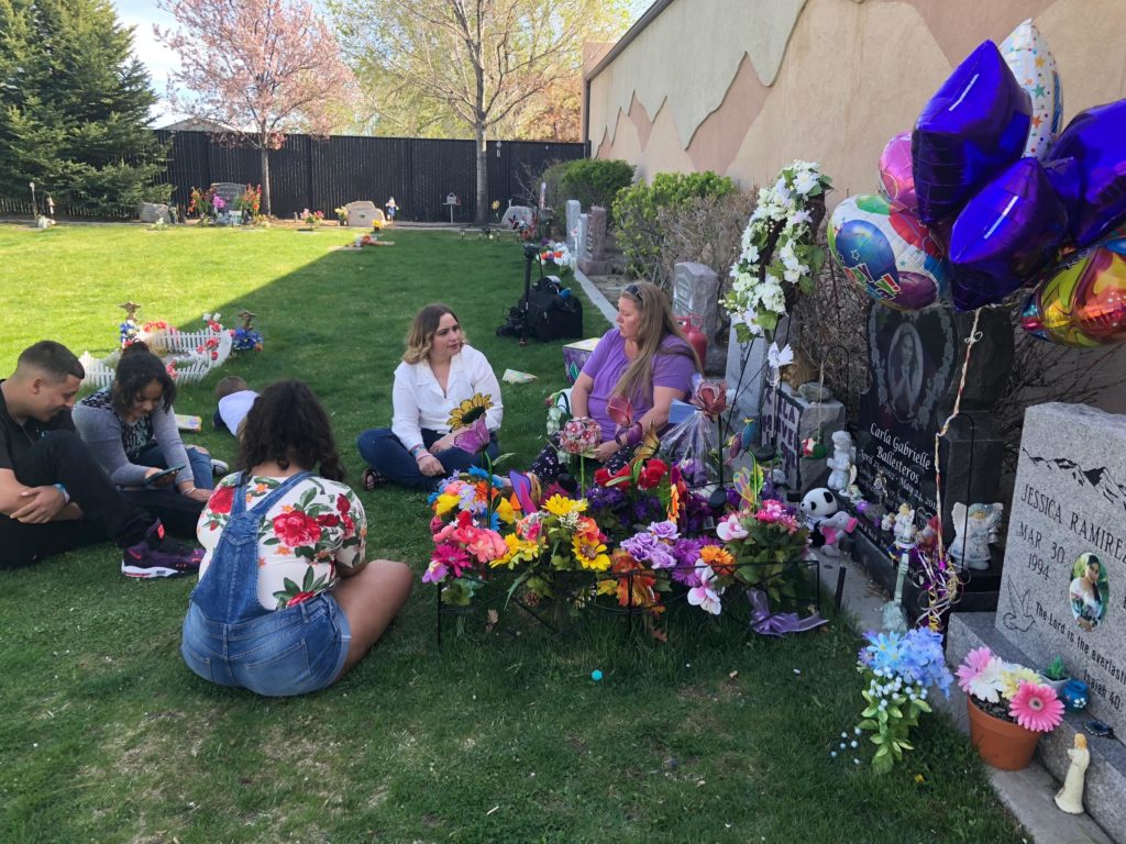 Family sits at gravesite