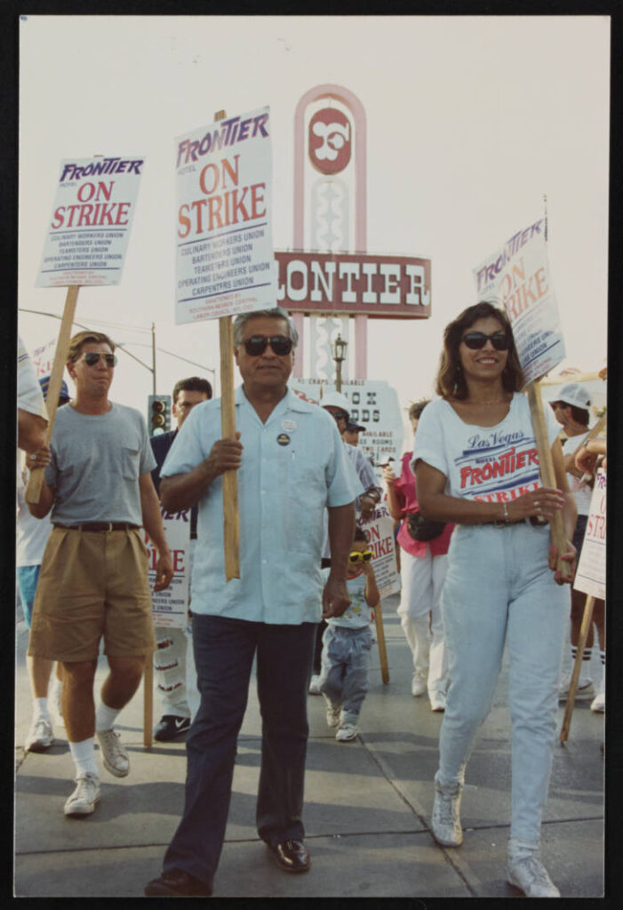 César Chávez with picket sign walks with Geoconda Argüello-Kilne