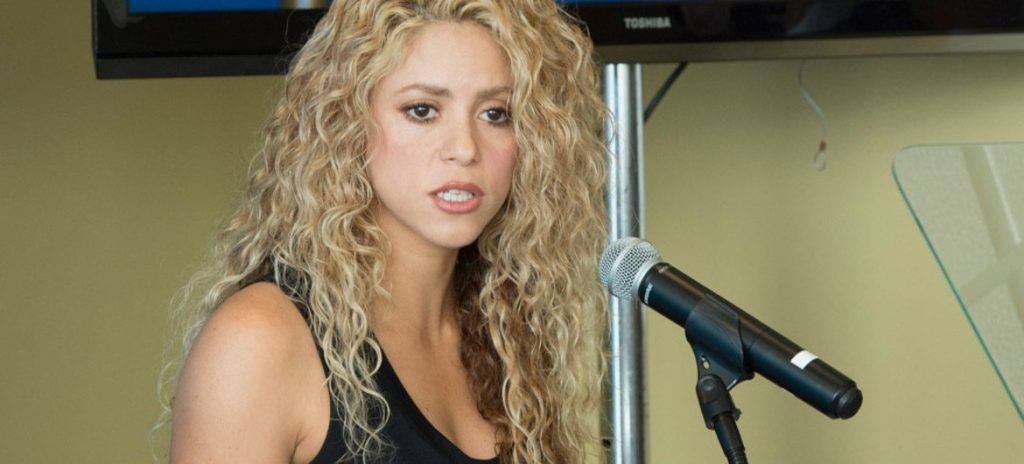 Shakira speaks into microphone