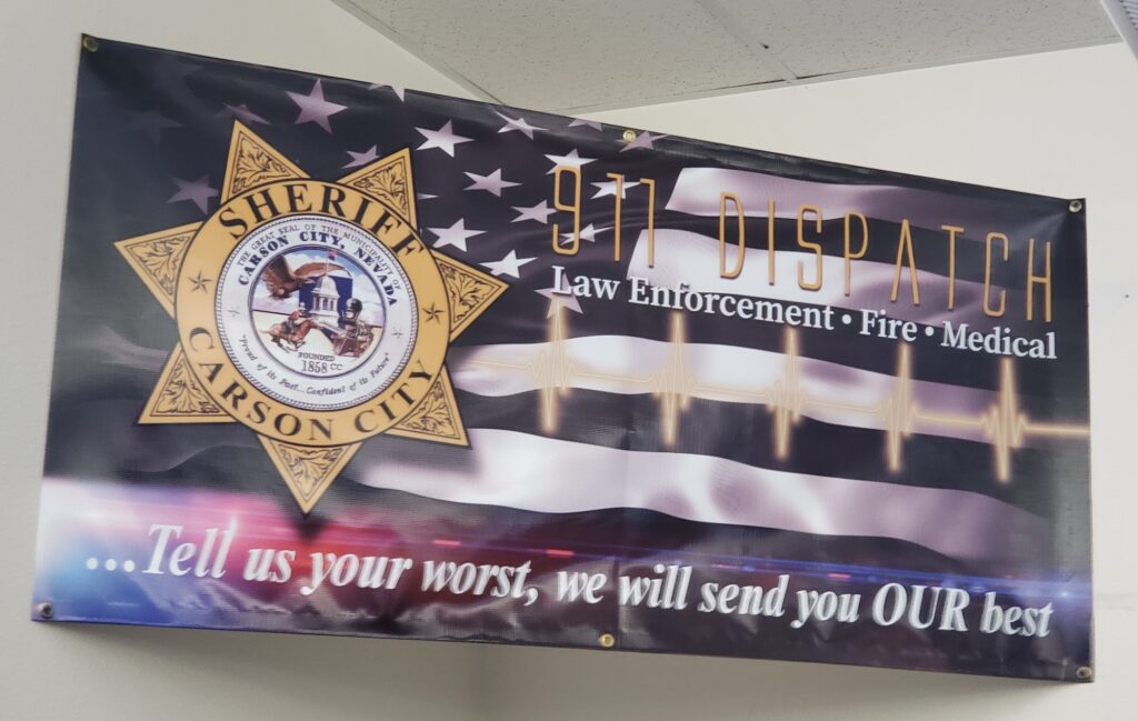 banner with Carson City Sheriff Office seal over U.S. Flag.