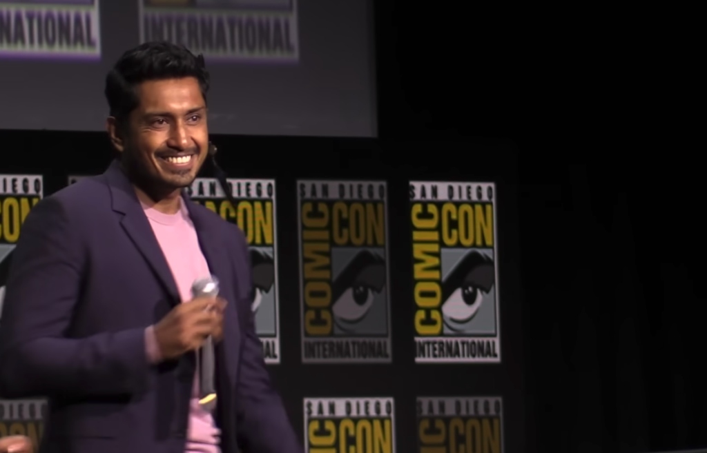 Man with microphone on stage at Comic Con