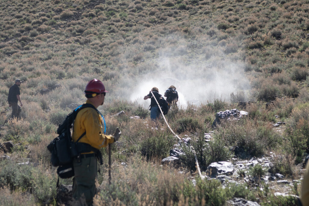 Students are pictured in firefighters gear out in a field