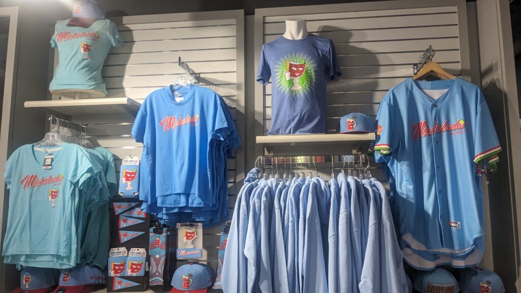 wall displaying t-shirts, baseball jerseys and hats