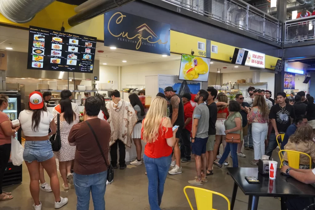 dozens of people wait to order Peruvian food