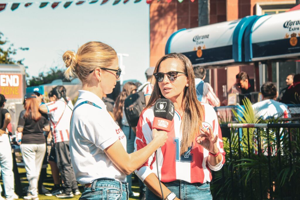 woman with microphone interviews another female