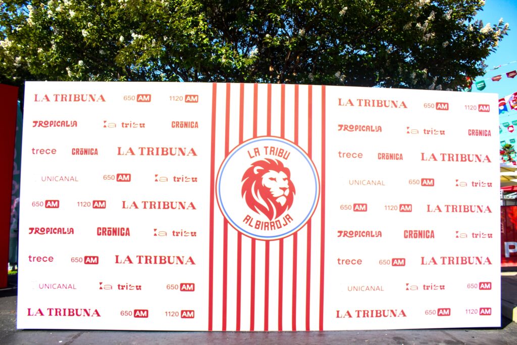 A large red-and-white poster featuring the names of Paraguayan media outlets