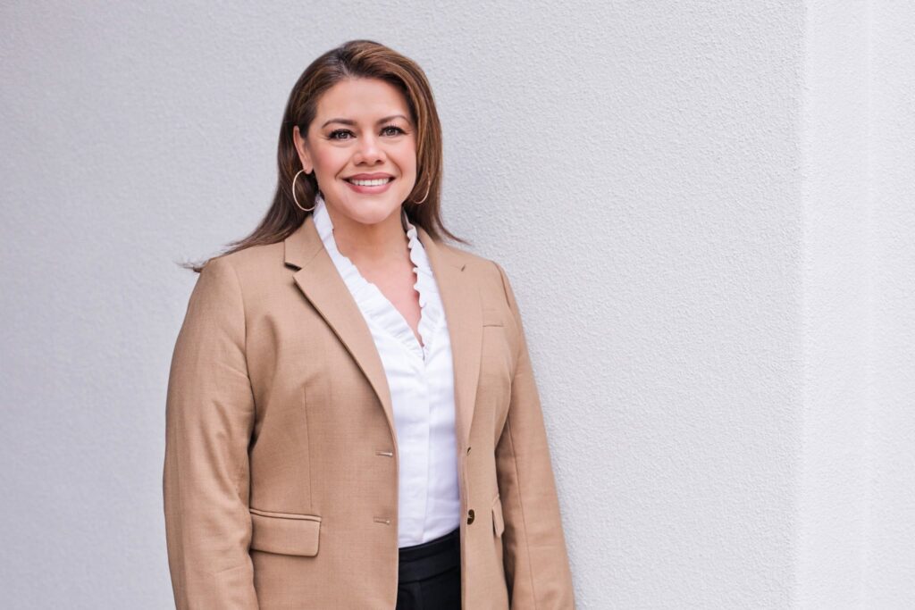 Woman smiling, standing and posing for photo