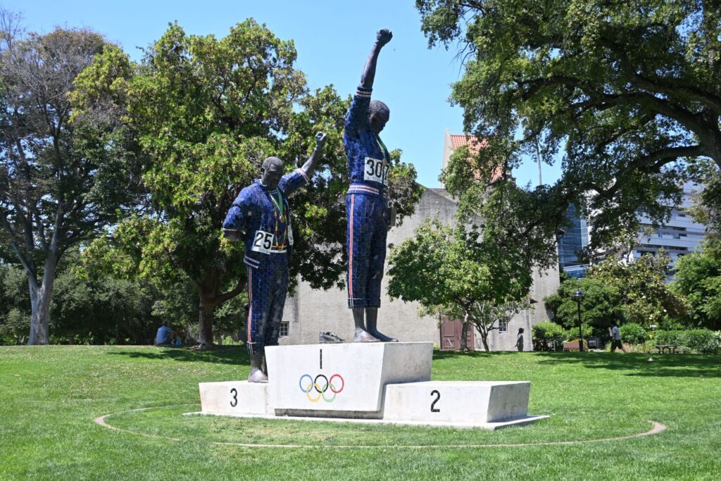 statue of Olympians with raised fists