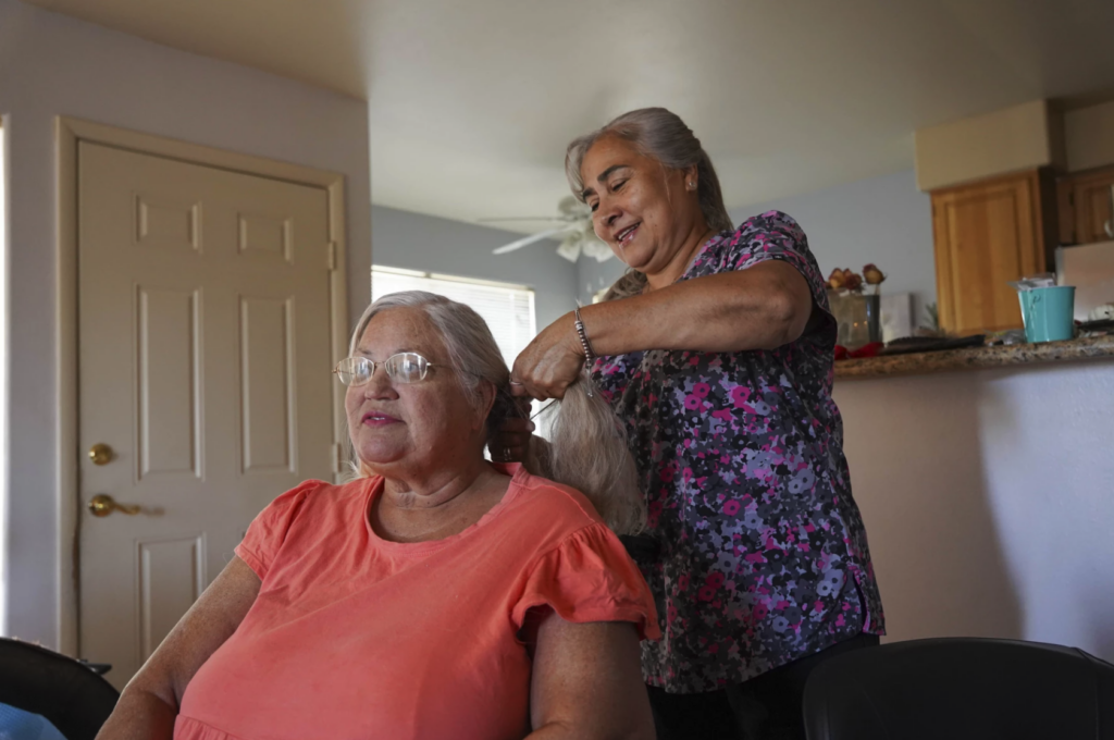 woman braids hair of another woman