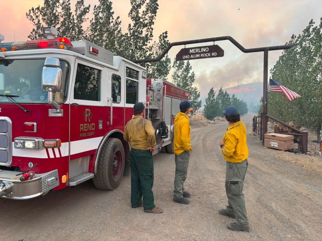 three firefighters discuss plans