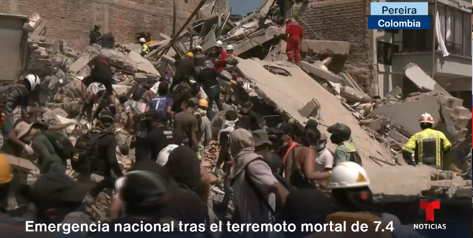 people digging through rubble