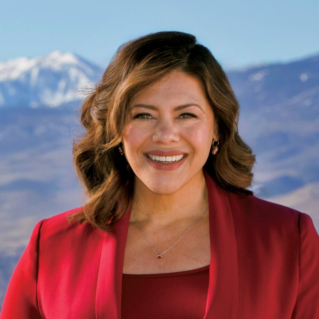 woman in red smiles at camara