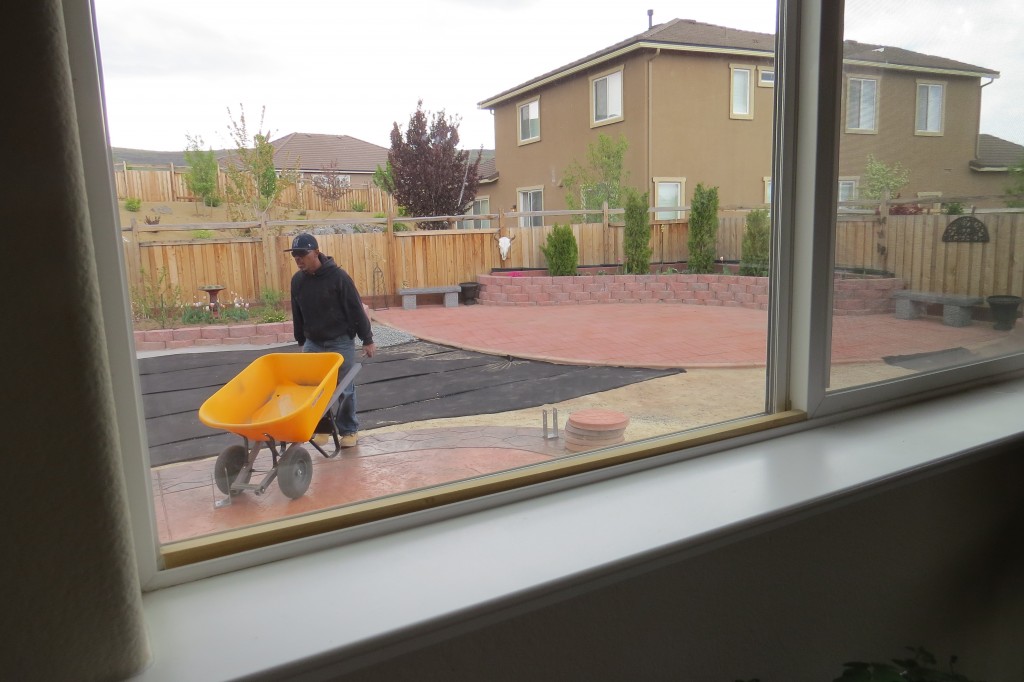 Eric using a wheelbarrow while working a landscape project.