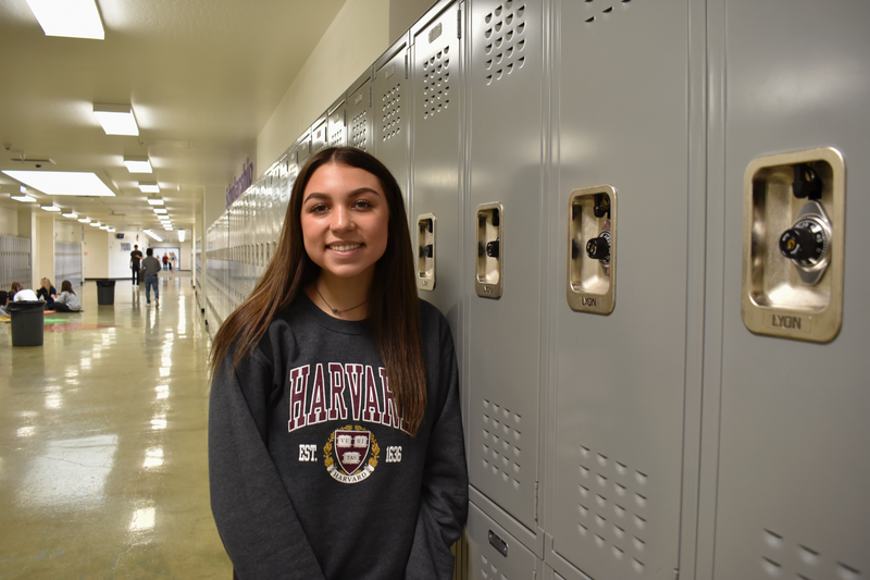 Spanish Springs High School senior, Riley Slane, poses in front of lockers.