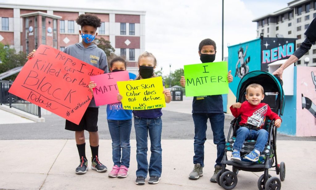 Kids in Reno hold up signs to protest police brutality