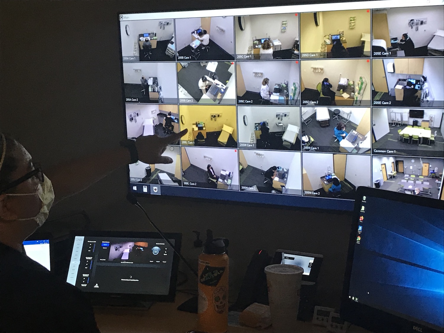 Monitor showing images of people in different rooms