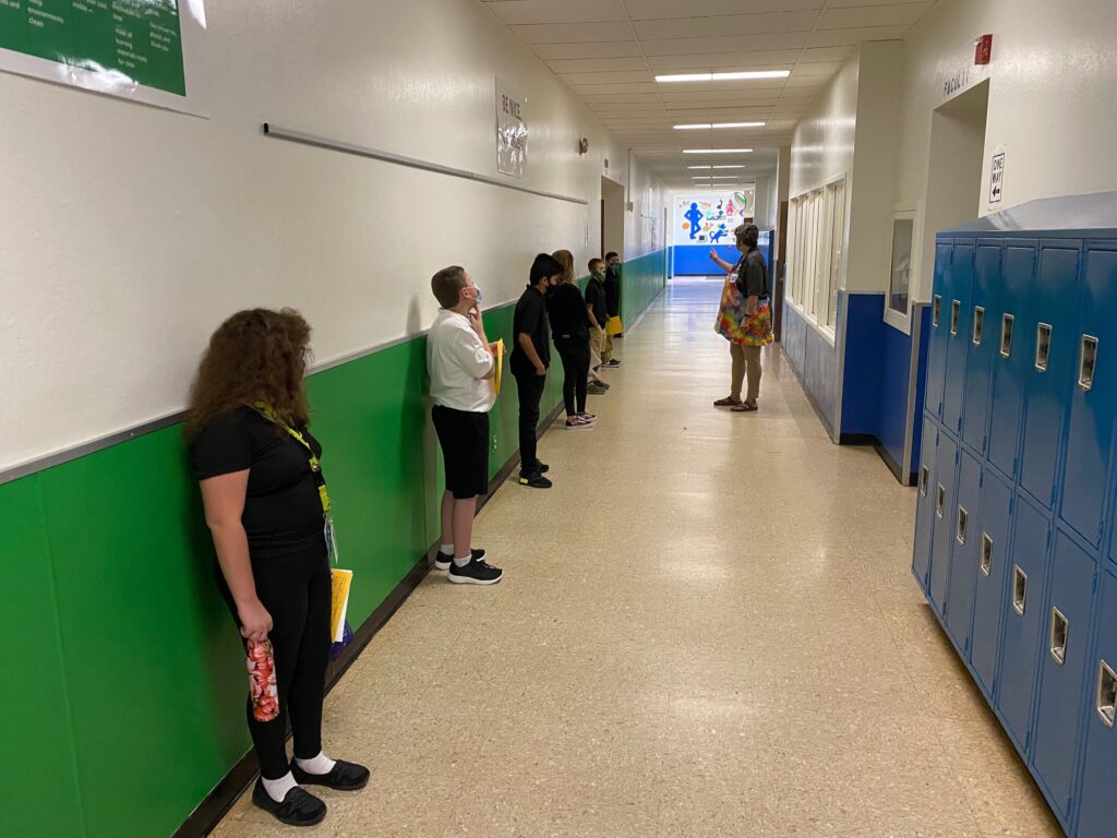 Students from a Washoe County elementary school waiting in school hallway to enter class.