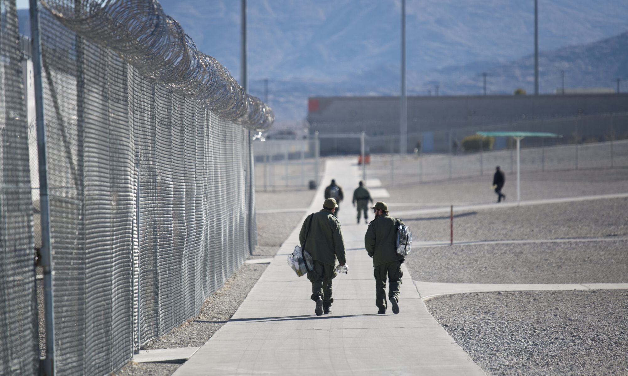 Guards walk inside High Desert State Prison