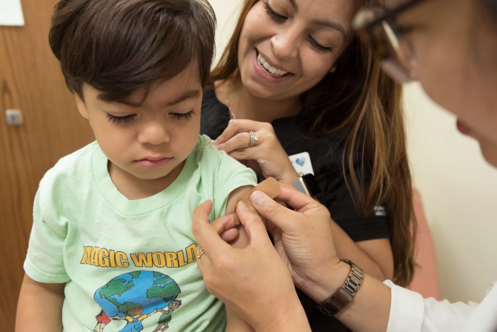boy gets band-aid after vaccine