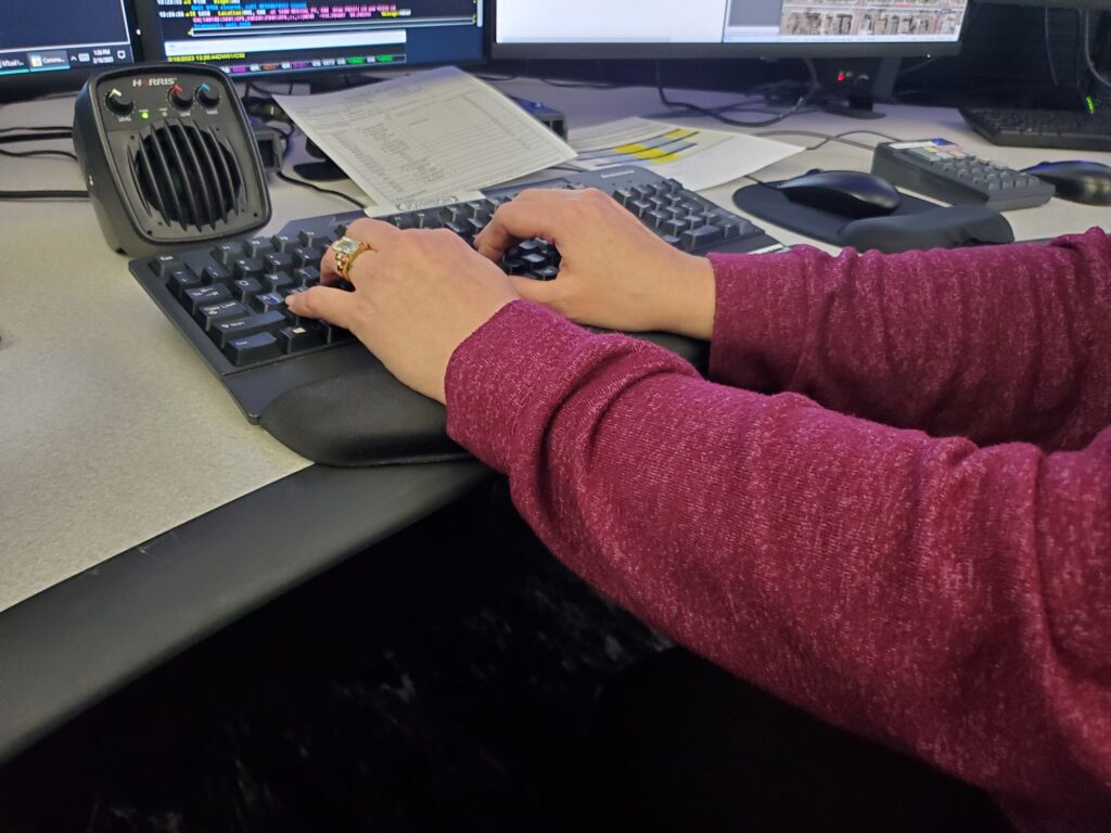 woman typing on computer keyboard