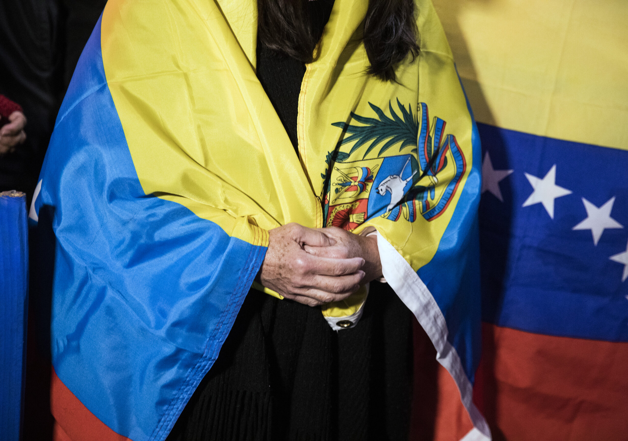 woman wrapped in Venezuelan flag