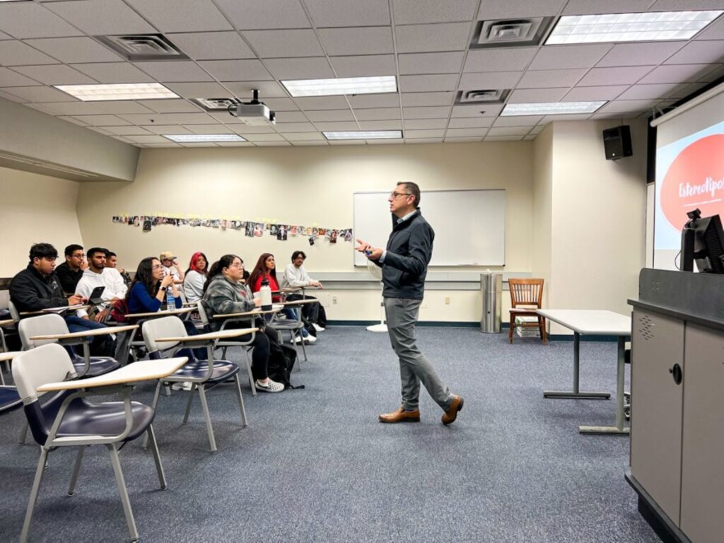 Professor stands in front of class lecturing students