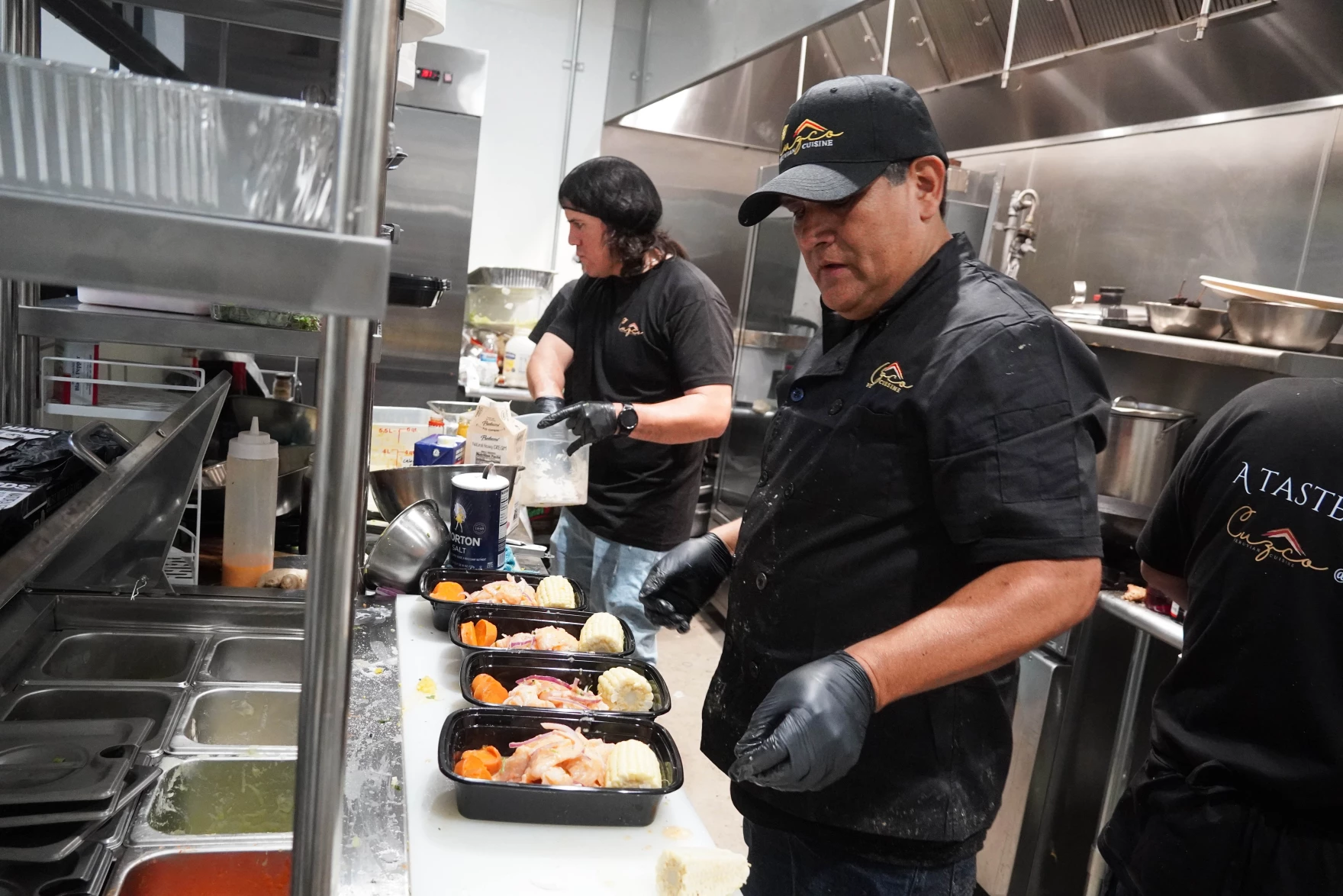 cooks prepare food at peruvian restaurant