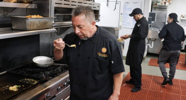 Man in kitchen taste food