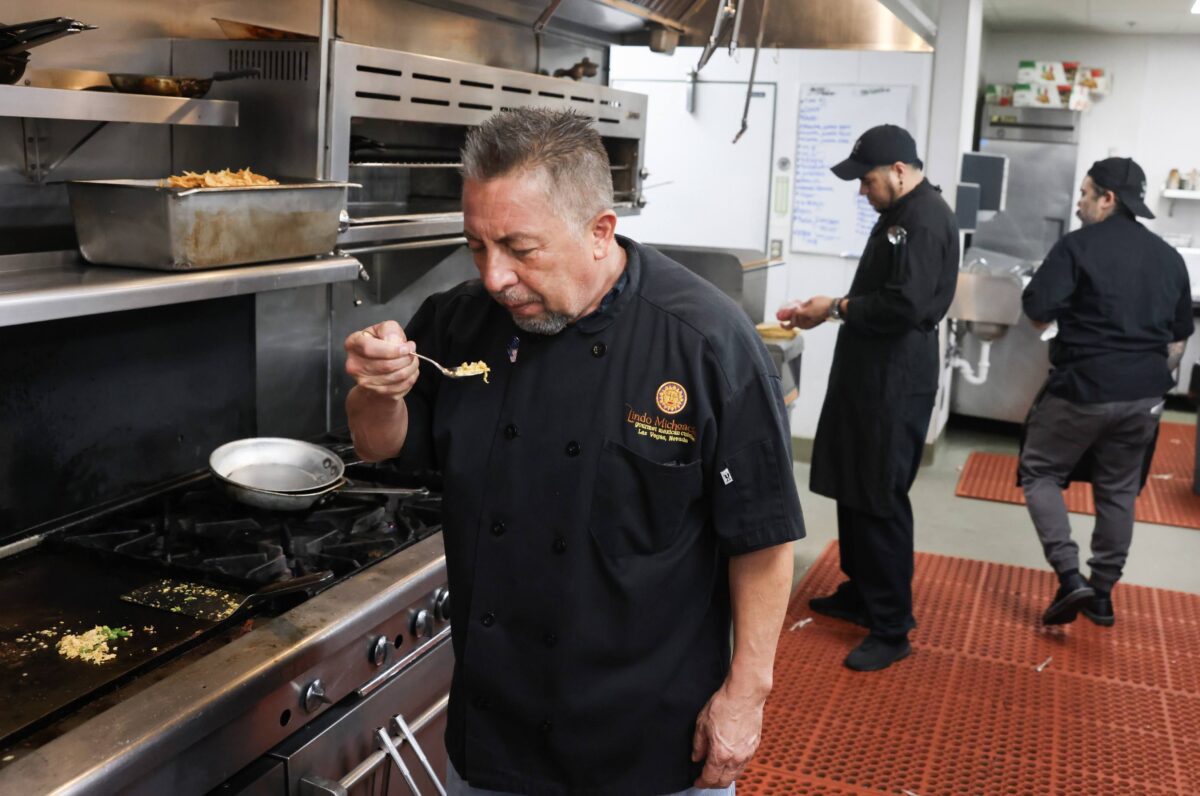 Man in kitchen taste food