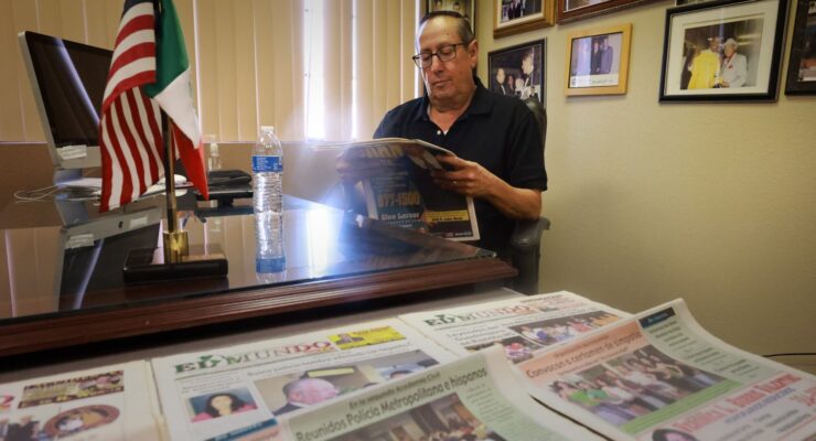 Eddie Escobedo Jr, reading the newspaper at his desk