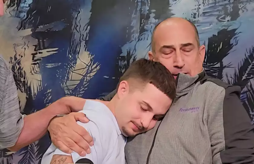 older man embraces younger man