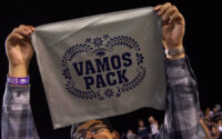 man holds hand towel with words in spanish 'vamos pack'