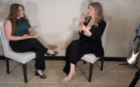 two women seated facing one another in an interview