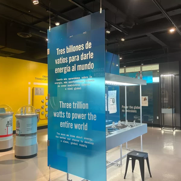 a blue poster with white lettering inside a hall
