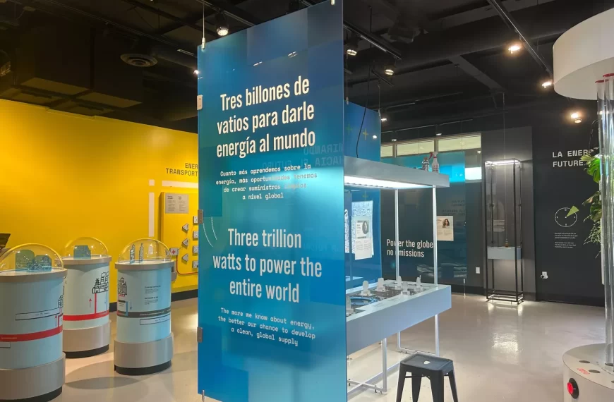 a blue poster with white lettering inside a hall