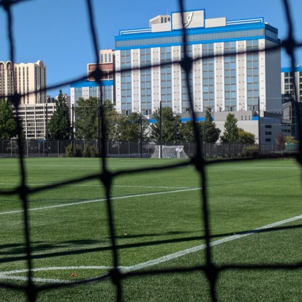 sports field with a hotel behind it