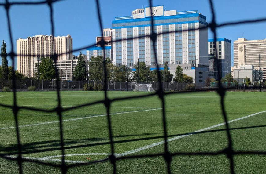 sports field with a hotel behind it