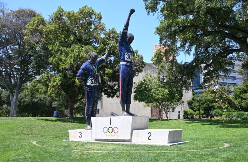 statue of Olympians with raised fists