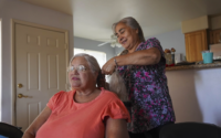 woman braids hair of another woman