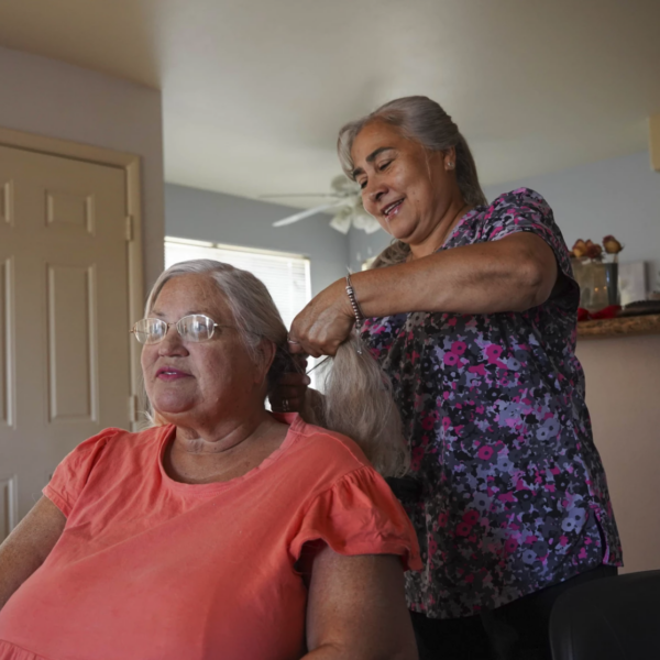 woman braids hair of another woman