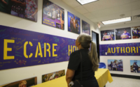 woman looks at photos on wall