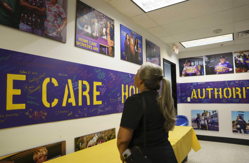 woman looks at photos on wall