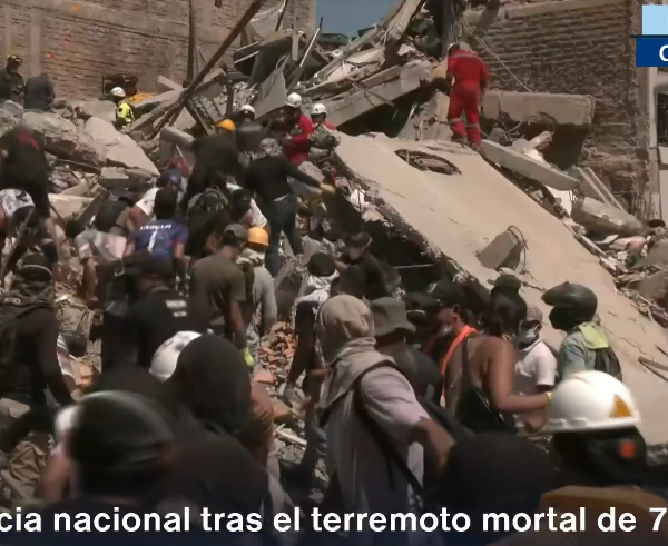 people digging through rubble