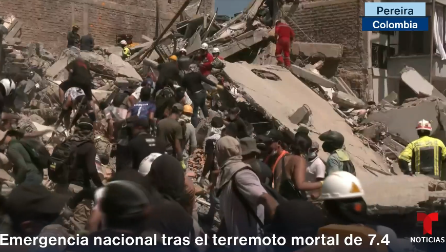 people digging through rubble